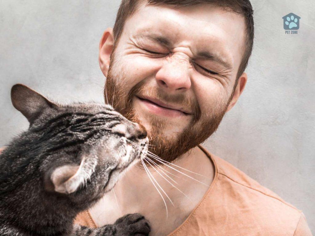 cat licking man with eyes closed