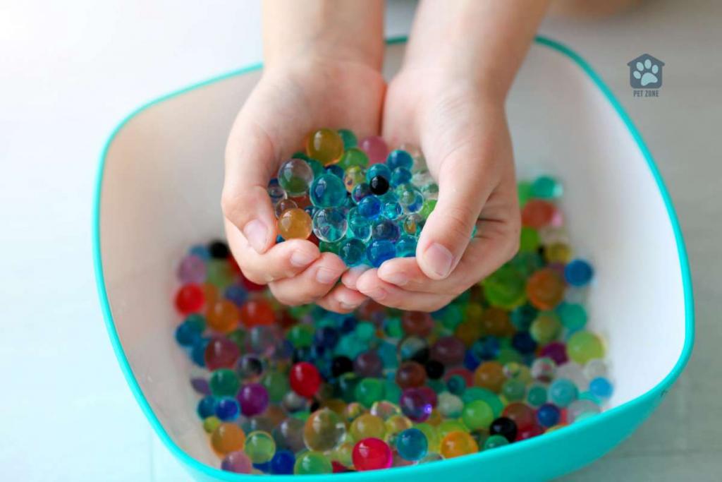 childs hands holding a scoop of orbeez