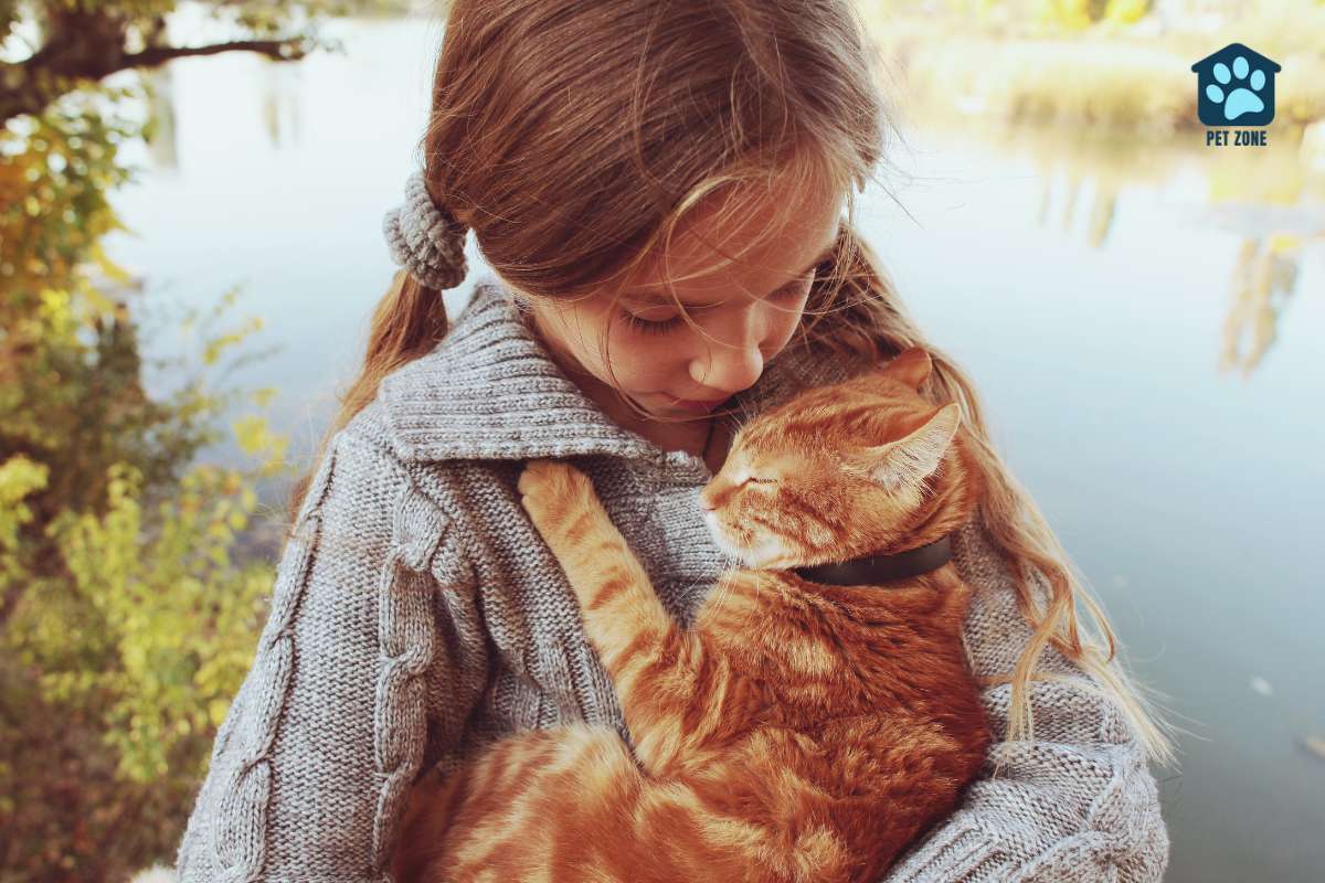 young girl cradling cat in arms
