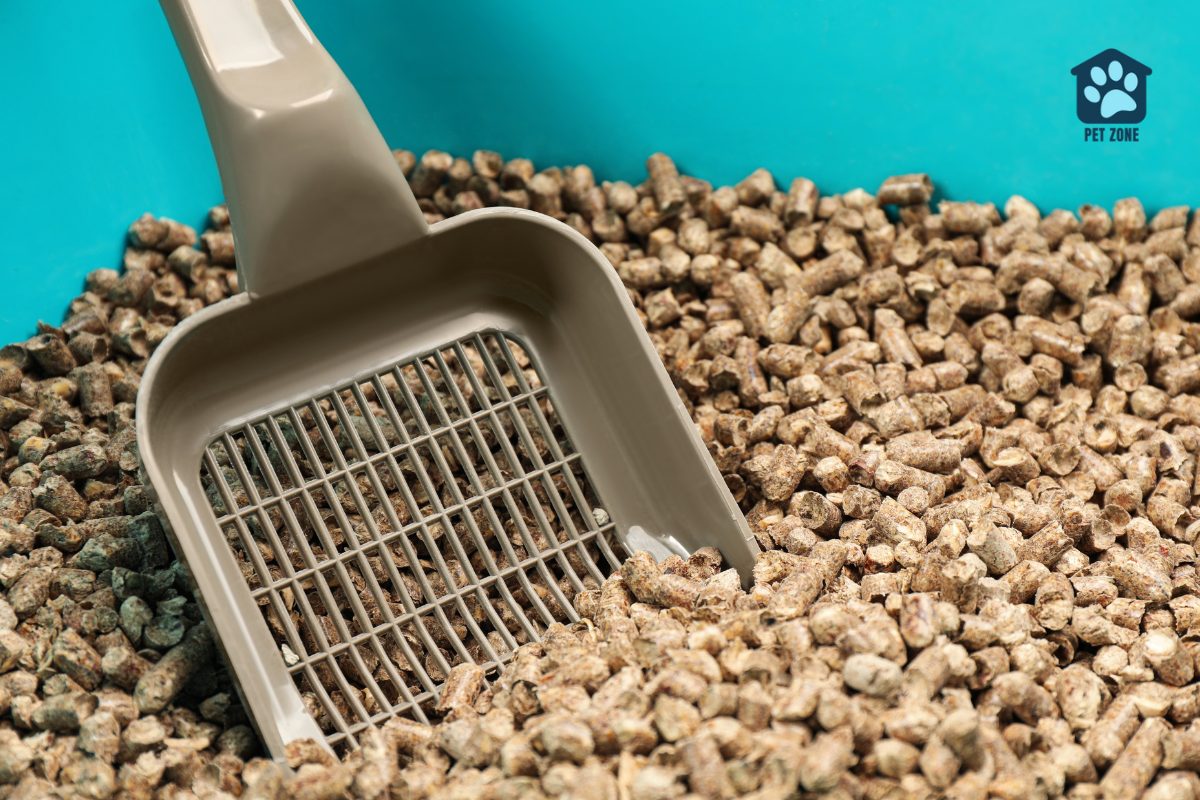 cat litter scoop in litter box filled with pellets