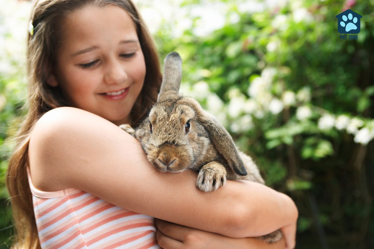 girl holding pet rabbit