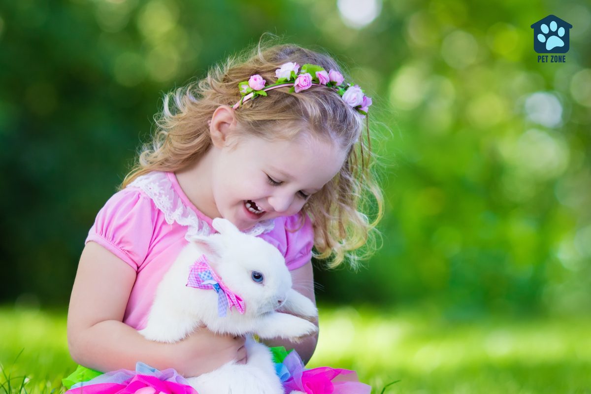 smiling little girl holding white bunny