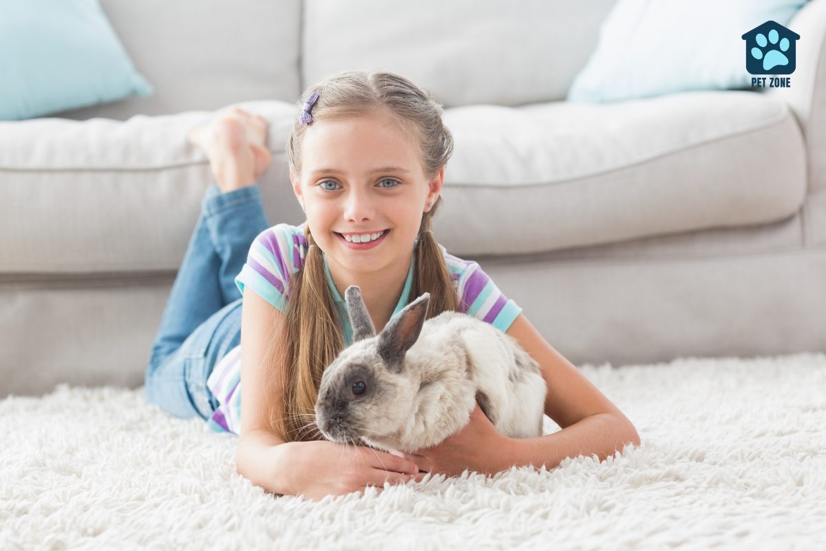 young girl laying on rug hugging her rabbit